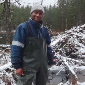 Jason standing in front of a snow-covered beaver dam