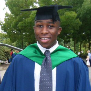 Jason in his graduation attire, standing outside of the UEA.