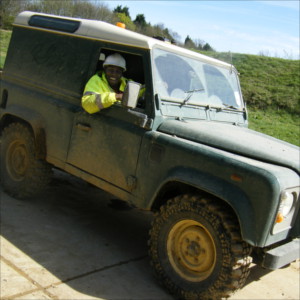 Jason sitting in a landrover in his position as an environmental monitor.
